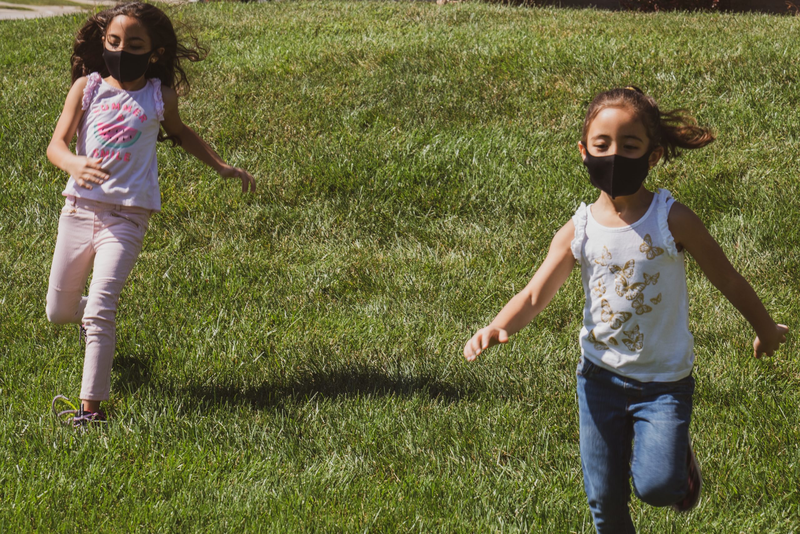 Childrem running down hill in team building activity